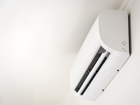Air conditioner cooling fresh system saving energy on white wall backgroundの写真素材