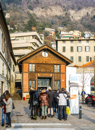 Como, Italy, January 1st 2016: Tourists waiting in queue at the Como funicular transport system stationのeditorial素材