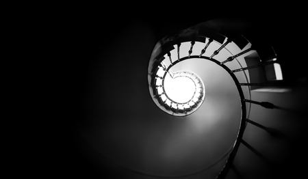Ancient spiral staircase seen from below. Black and white shotの写真素材