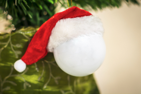 hanging decorative white ball for Christmas tree with Red Hat of Santa Clausの写真素材