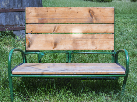 an old wooden bench in a green meadow. Free day and vacation conceptの写真素材