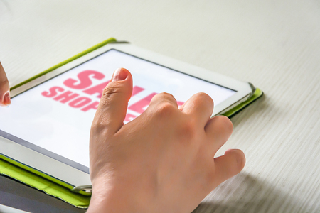 Young woman using a tablet to shop online. Technology and internet connection concept.の写真素材