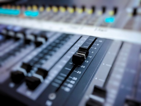 Professional audio mixer console with black knobs to equalize sounds. Audio recording studio tool. Music and entertainment conceptの写真素材