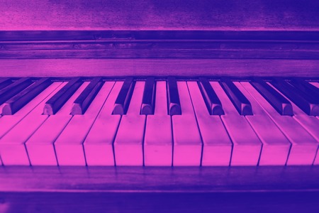 close-up view of the keys of a ancient ruined piano. Purple duotone effectの写真素材