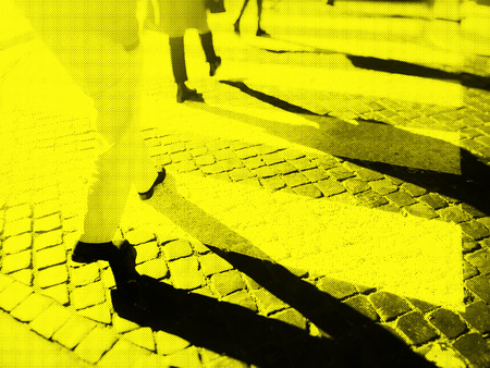 Blurry city zebra crossing with walking pedestrians legs making long shadows. Duotone effect with textureの写真素材