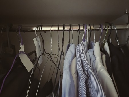 interior of a wardrobe with various shirts hung with hangers