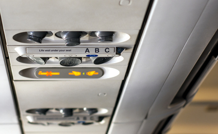 control panel to regulate the direction of personal lights, air conditioning, with the indication of smoking ban and to keep the safety belts fastened inside a flight cabin of an airplaneの写真素材