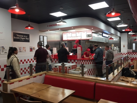Barcelona, Spain, April 2019; People queuing at the Five Guys fast food restaurant counter in Barcelona, Spainのeditorial素材