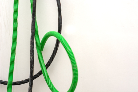Black and green corrugated bellow conduit tube for electrical wiringの写真素材