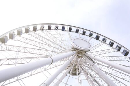 Bottom view of a ferris wheel against a clear sky. Architecture and amusement parks. Fun and tourist...