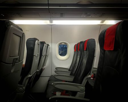 window of a commercial airliner with empty seats. Concept of air travel and vacationの写真素材