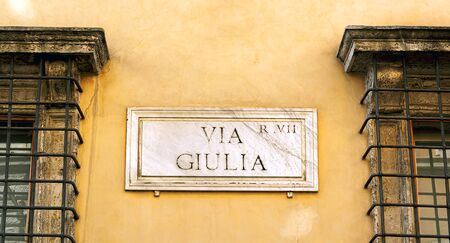 The indication of the Via Giulia address in an old marble sign in Rome.の写真素材