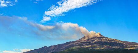 Overview of Mount Etna in Sicily during an eruption with smoke and ash release.の写真素材