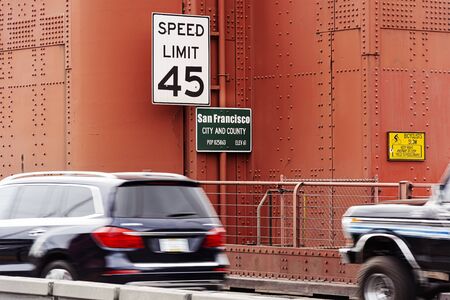 Traffic signs about speed limits and information panels on a tower of the Golden Gate Bridge in San...