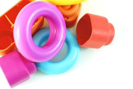 Colored plastic rings and rubber bricks for children to play. Children's toys. Growth and learningの写真素材