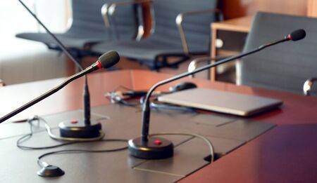 microphone on a wooden table of a boardroom. Business conceptの写真素材