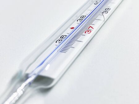a mercury thermometer isolated on a white background. Medical measuring instrument. Virus and fluの写真素材