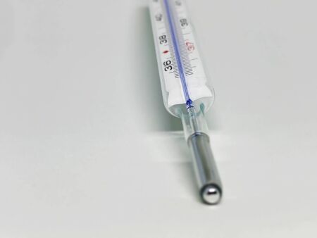a mercury thermometer isolated on a white background. Medical measuring instrument. Virus and flu
