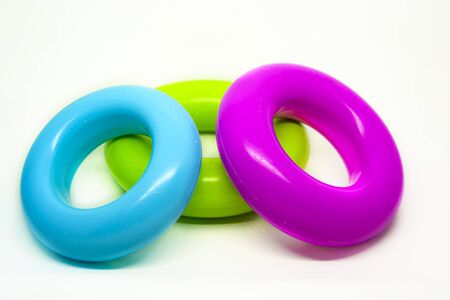 three colored plastic rings isolated on a white background. Children's toys for stacking. Preschool...