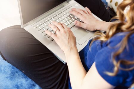 young caucasian woman typing on laptop keyboard. Working from home. Smart working conceptの写真素材