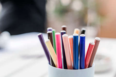 a group of colored markers in a plastic container. Creativity and drawing. Selective focus.の写真素材