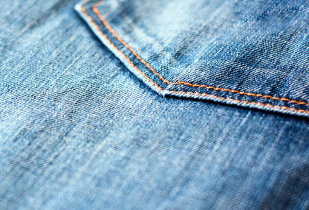 Detail of the denim fabric of a pair of jeans with the seam of the pocket.の写真素材