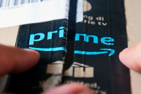 Rome, Italy, august 2020: opening a box shipped by Amazon Prime. Business and online shopping. International shipments. Cardboard packagingのeditorial素材