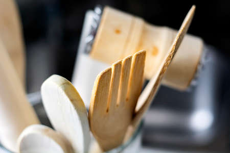close-up view of a group of wooden kitchen utensils. Selective focus on the fork. Tools for cookingの写真素材
