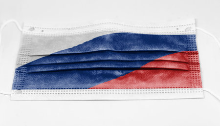 The national flag of Russia printed on a disposable surgical mask. Coronavirus covid-19 pandemic prevention and protection. Health and medicineの写真素材