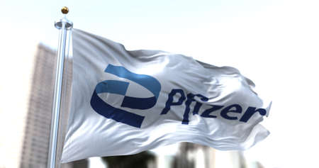 Rome, Italy, January 26, 2021: White flag with the new Pfizer logo waving in the wind. Pfizer is an American pharmaceutical company that has produced a vaccine for the Covid-19 coronavirusのeditorial素材