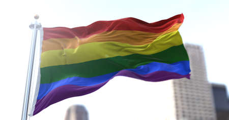 the rainbow flag flapping in the wind. Symbol of gay pride and peace. Human rightsの写真素材