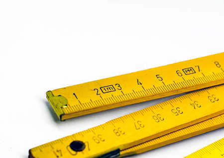Detail of a folding wooden meter. Measuring tool for construction and renovation works. Graduated...