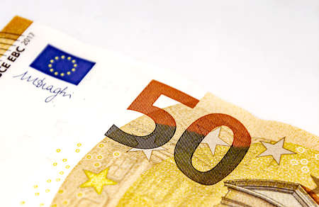 Detail of a 50 euro banknote isolated on a white background. European Union currency. Economics and finance. Paper cash. Copy spaceの写真素材