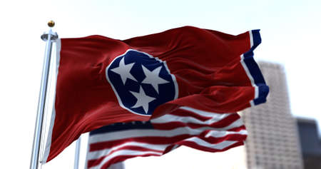 The flags of the Tennessee state and United States of America waving in the wind. Democracy and independence. American state.の写真素材