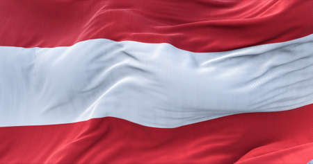 Close-up view of the national flag of Austria waving in the wind. Democracy and independence.の写真素材