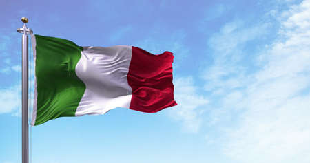 The national flag of Italy flying in the wind. Outdoors and sky in the background. Democracy and...