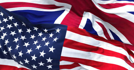 The flags of the United States and the United Kingdom waving in the wind. International relations and diplomacy.の写真素材