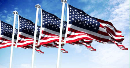 Four flags of the United States of America waving in the wind. Clear sky in the background....