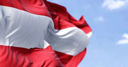 Detail of the national flag of Austria waving in the wind on a clear day. Democracy and politics....