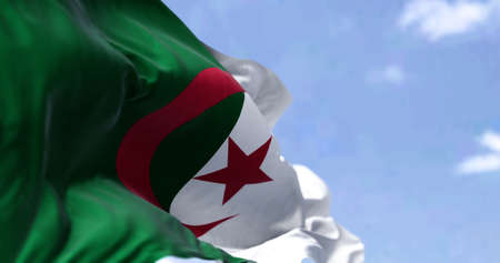 Detail of the national flag of Algeria waving in the wind on a clear day. Patriotism. Selective focus.の写真素材