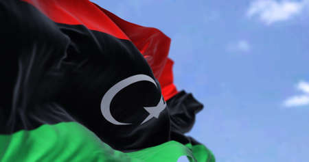 Detail of the national flag of Libya waving in the wind on a clear day. Patriotism. North african country. Selective focus.の写真素材