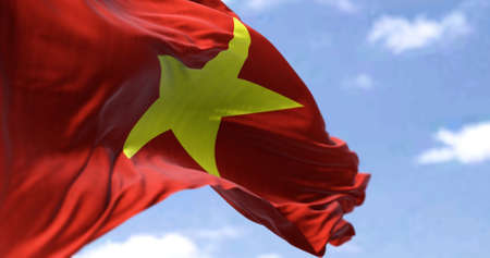 Detail of the national flag of Vietnam waving in the wind on a clear day. Socialist Republic. Patriotism. Selective focus. Southeast asian country.の写真素材