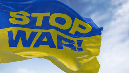 Detail of the national flag of Ukraine with the "stop war" text waving in the wind . Democracy and politics. Patriotism. Selective focus. Seamless Slow motionの写真素材