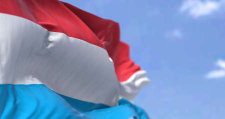 Detail of the national flag of Luxembourg waving in the wind on a clear day. Luxembourg is a landlocked country in Western Europe. Selective focus.の写真素材