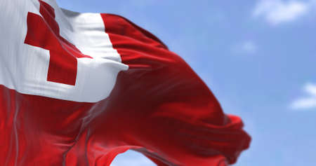 Detail of the national flag of Tonga waving in the wind on a clear day. Tonga is a Polynesian...