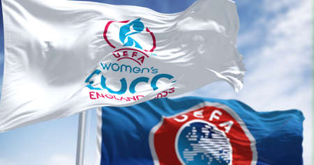 London, UK, May 2022: The flag of the UEFA European Womenâs Football Championship Euro 2022 flying alongside the blurred UEFA flag. Womenâs Euro 2022 will take place in England from 6 to 31 Julyのeditorial素材