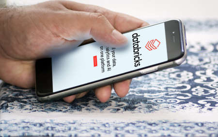San Francisco, CA, US, May 2022: hand holding a phone with Databricks company web page on screen....