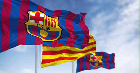 Barcelona, Spain, May 2022: two flags of FC Barcelona are waving in the wind with the Catalonia flag in the middleのeditorial素材