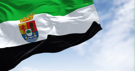 The Extremadura flag waving in the wind on a clear day. The Extremadura is an autonomous community of Spain. Its capital city is Meridaの写真素材