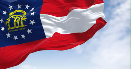 The state flag of Georgia waving in the wind. Georgia is a state in the Southeastern region of the United States. Democracy and independence.の写真素材